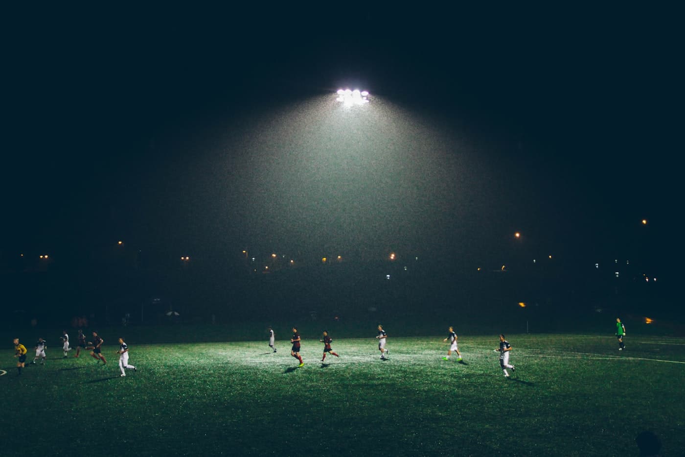 Teams competing in kit under the lights